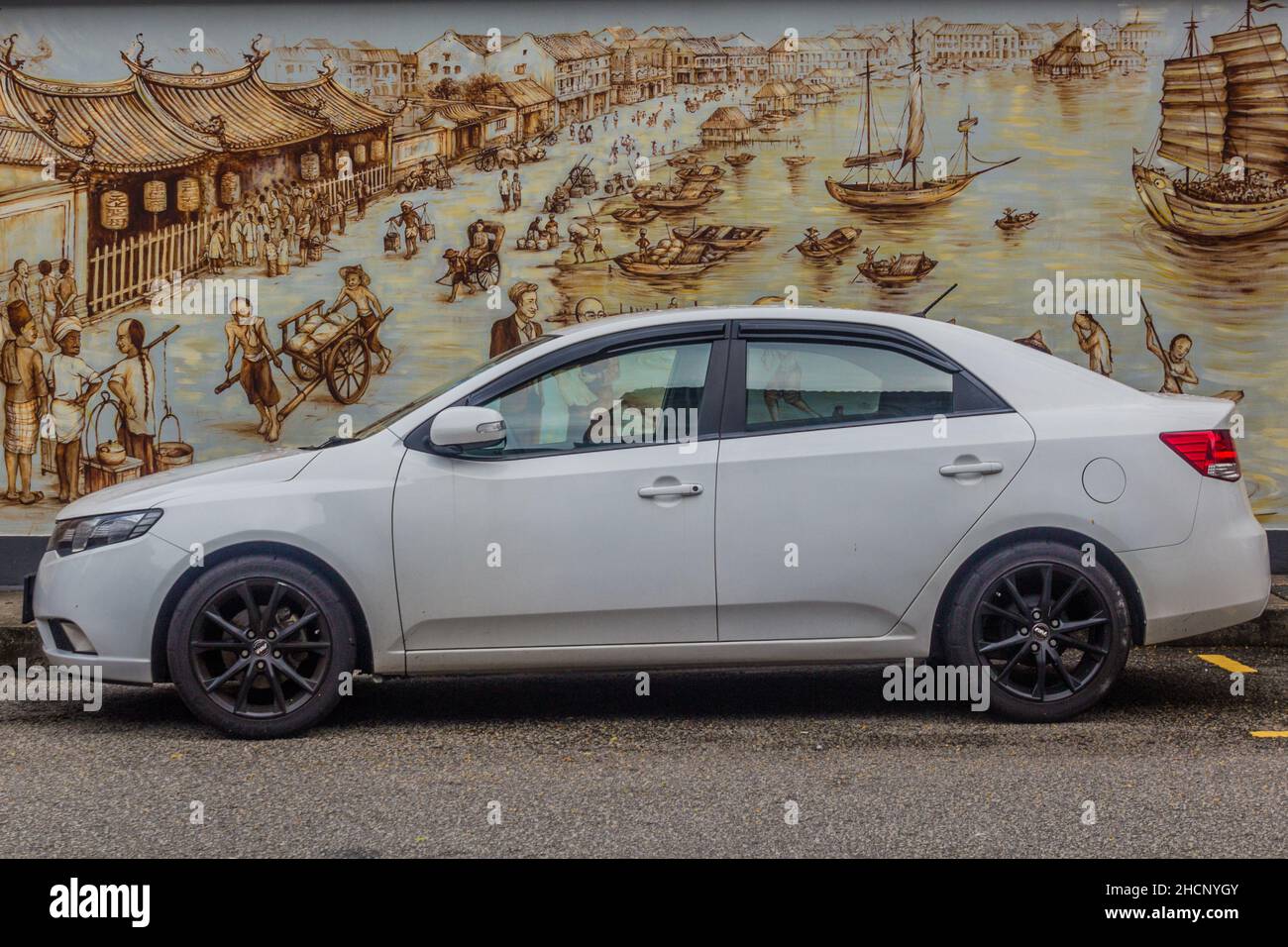 SINGAPORE, SINGAPORE - MARCH 12, 2018: Modern car in front of a wall painting of an old Singapore Stock Photo