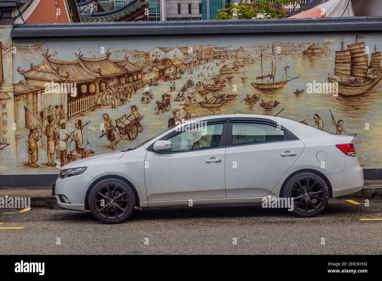 SINGAPORE, SINGAPORE - MARCH 12, 2018: Modern car in front of a wall painting of an old Singapore Stock Photo