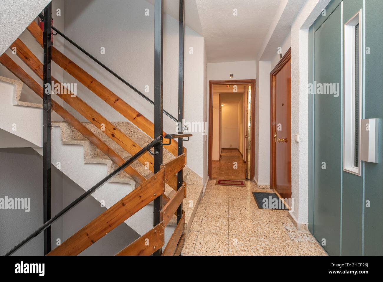 Stairs of residential apartment building with elevator and stone tile flooring Stock Photo
