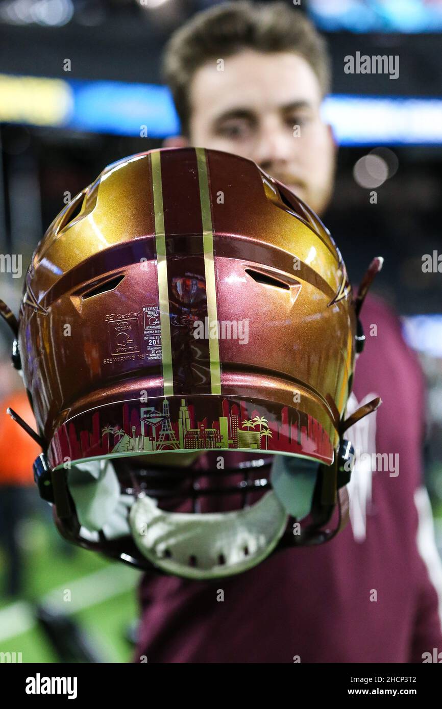 Las Vegas, NV, USA. 30th Dec, 2021. Jarod Zimmerman, Student Equipment Manager, holds an ASU helmet displaying the Las Vegas skyline prior to the start of the SRS Distribution Las Vegas Bowl featuring the Wisconsin Badgers and the Arizona State Sun Devils at Allegiant Stadium in Las Vegas, NV. Christopher Trim/CSM/Alamy Live News Stock Photo