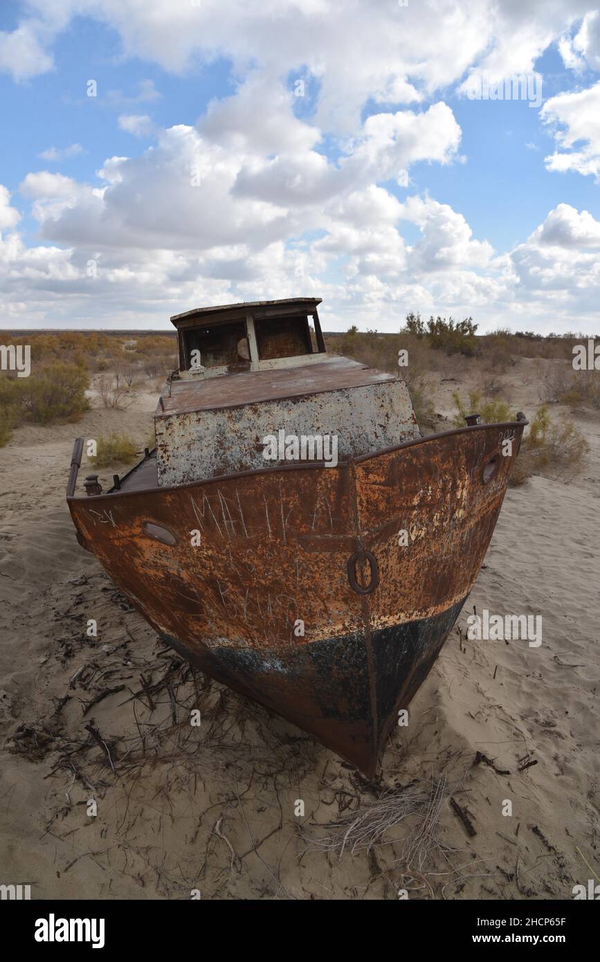Mujnak, Uzbekistan. 21st Oct, 2021. A rusty ship stands in the sand of the former port city from which the water retreated decades ago. The salt and sand desert of Aralkum continues to grow. The region is considered the biggest ecological disaster on earth. (to the KORR report 'Eco-disaster Aral Sea: The fight for its remains continues') Credit: Ulf Mauder/dpa/Alamy Live News Stock Photo