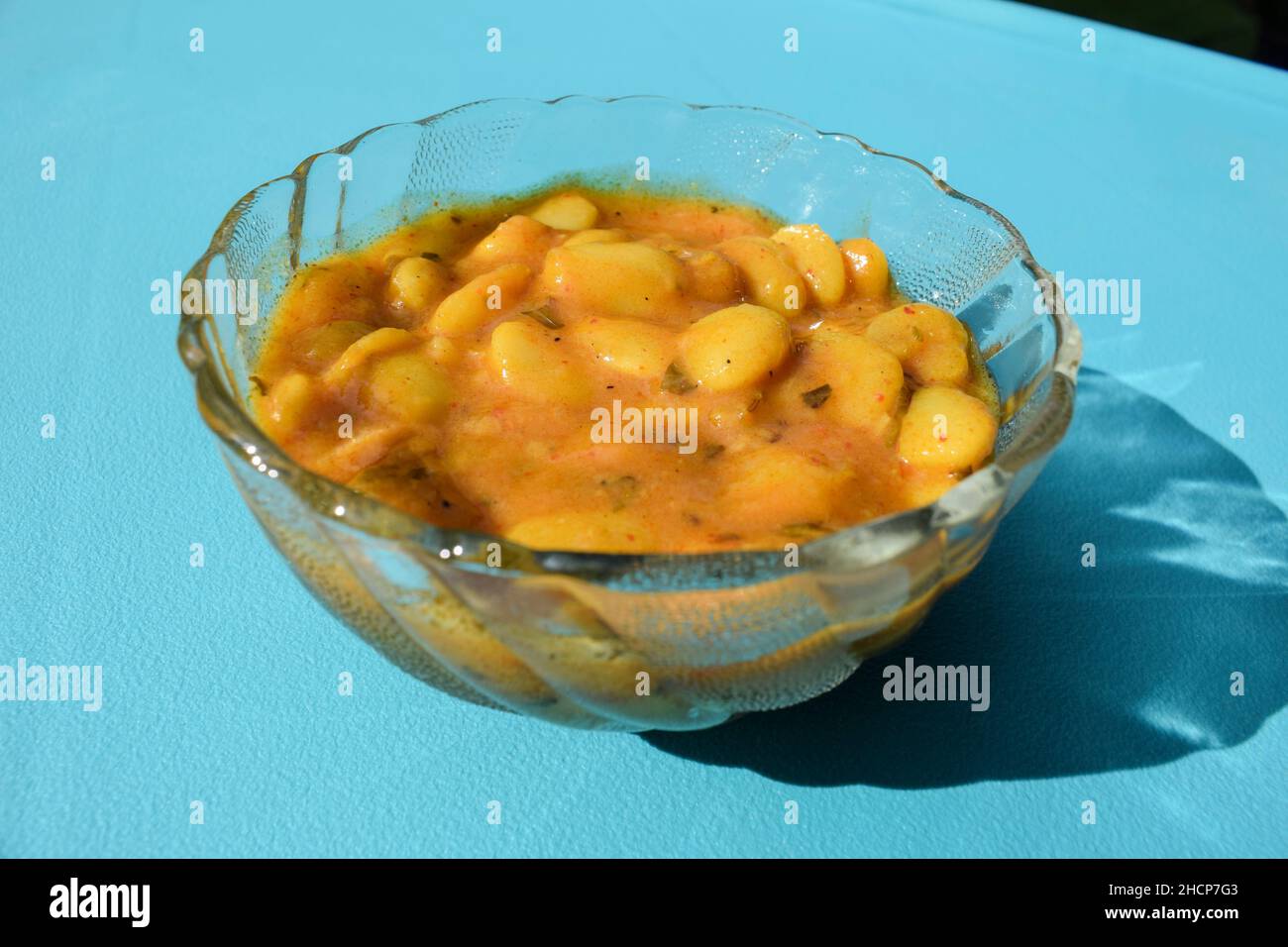 Delicious Vaal nu shaak or Butter beans curry served in transparent bowl on blue background isolated. Tasty Indian traditional curry lima beans or fav Stock Photo
