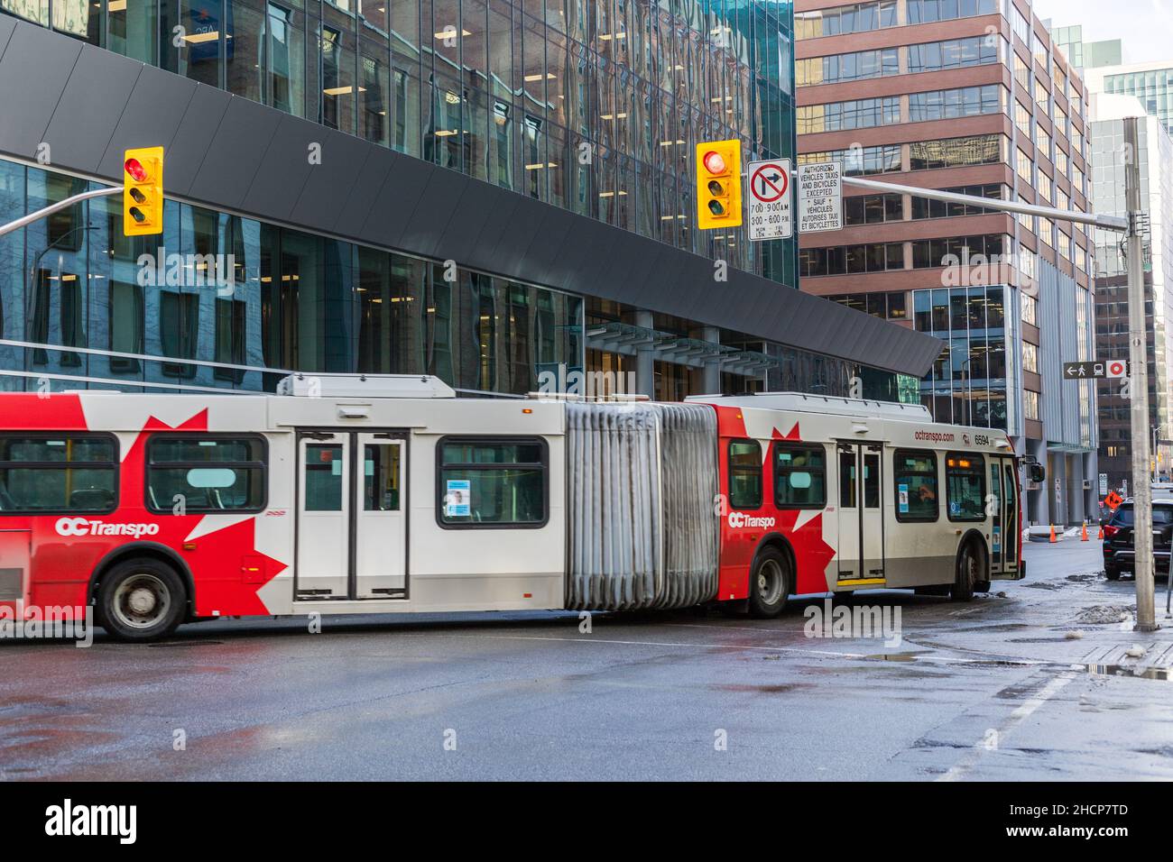 Ottawa, Canada - December 16, 2021: Public bus on thre road in downtown of the city , turning at intersection with traffic lights Stock Photo