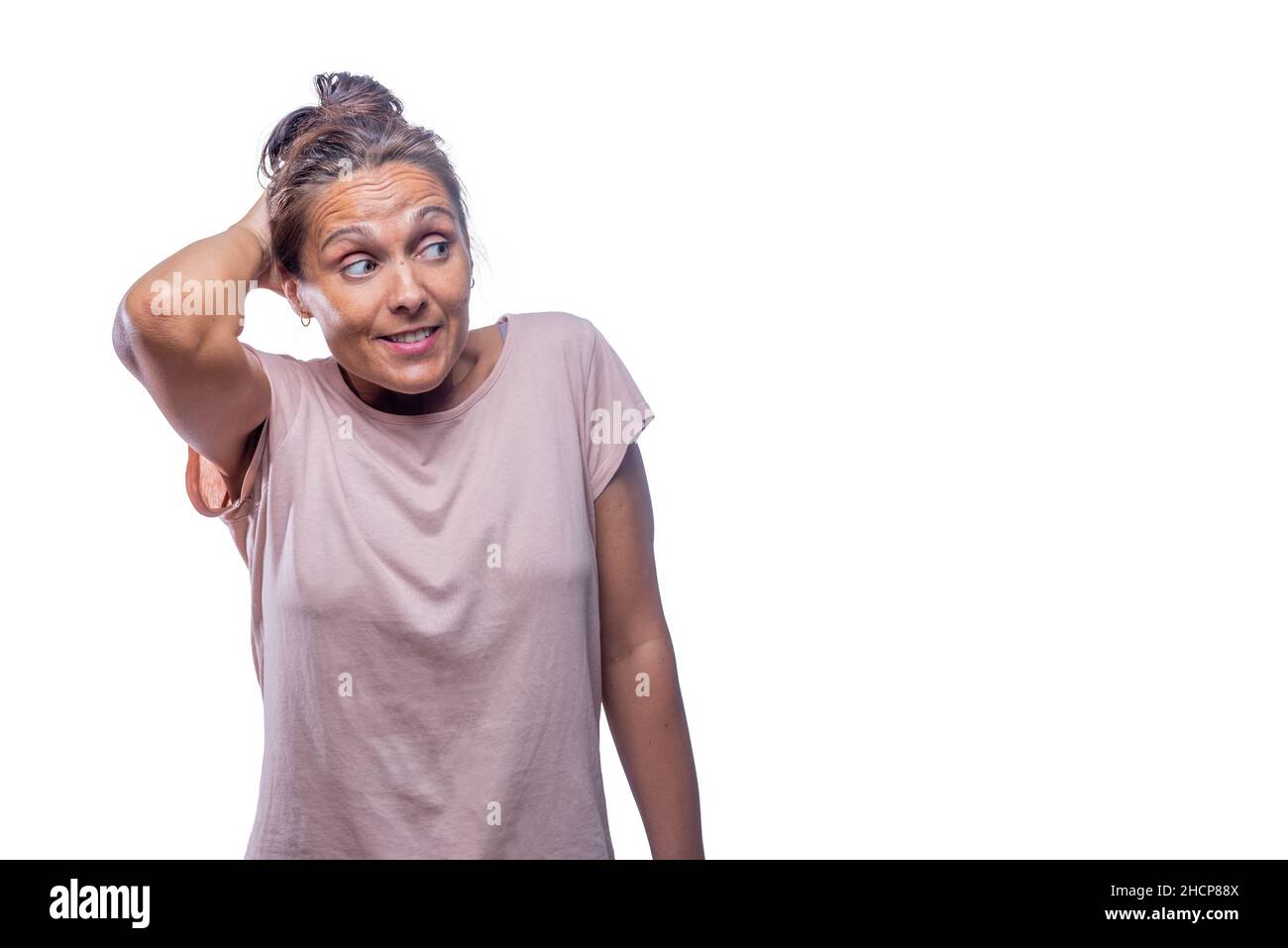 embarrassed woman looking to a side on a white background Stock Photo