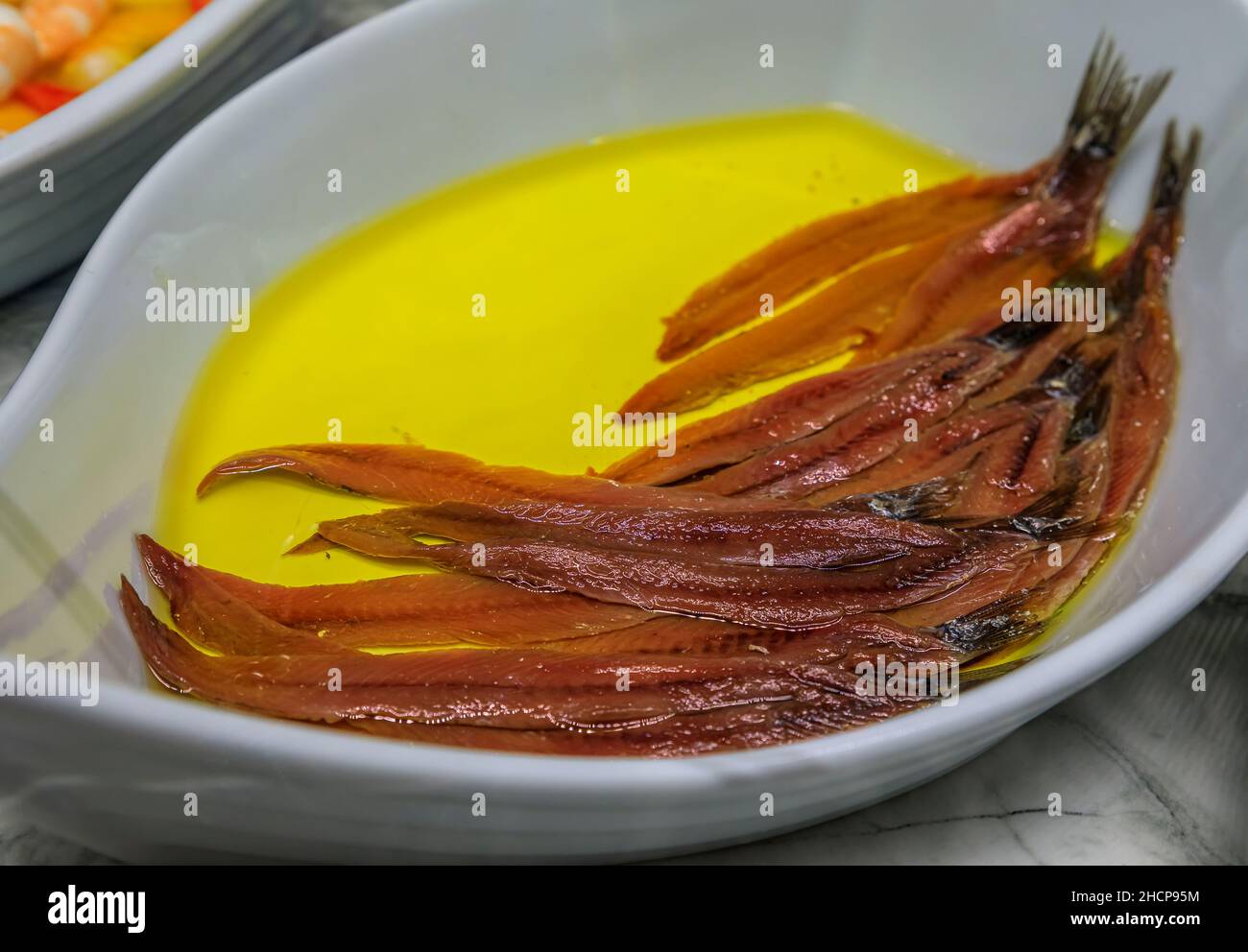 Traditional Spanish pintxos of Cantabrian anchovies in olive oil in a