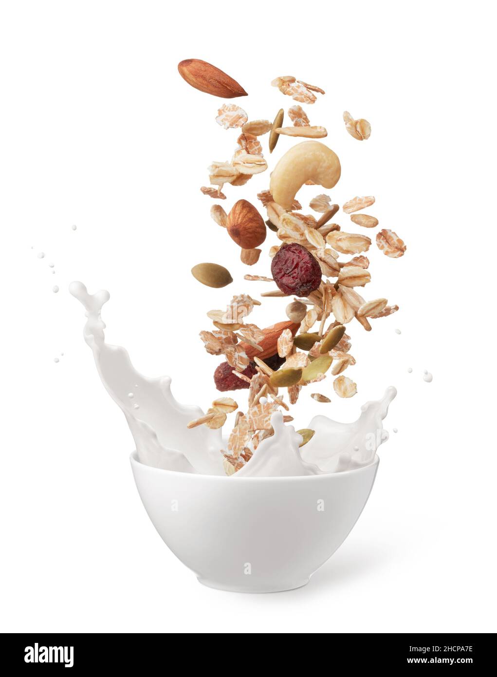 muesli dropping into bowl of milk creating splash Stock Photo Alamy