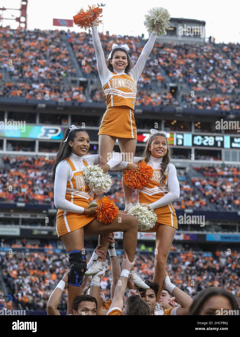 Nashville, TN, USA. 30th Dec, 2021. The Tennessee cheerleaders build a human pyramid during the TransPerfect Music City Bowl football game between the Purdue Boilermakers and the Tennessee Volunteeers at Nissan Stadium in Nashville, TN. Kyle Okita/CSM/Alamy Live News Stock Photo