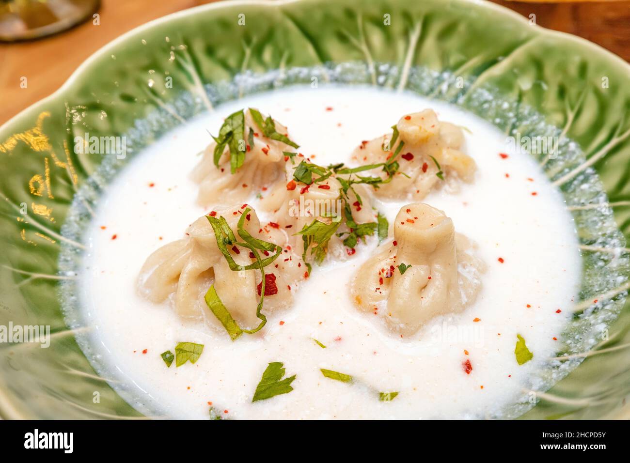 A traditional dish of Georgian cuisine is khinkali with broth in ...