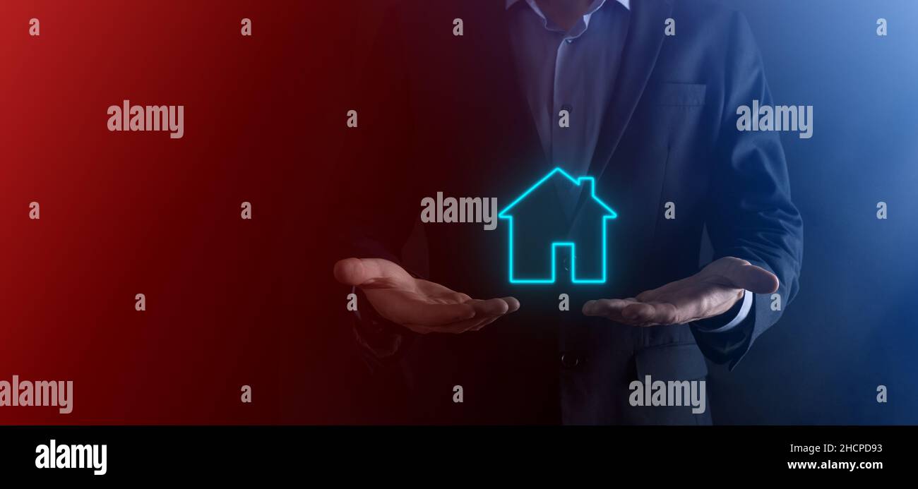 Real estate concept, businessman holding a house icon.House on Hand ...