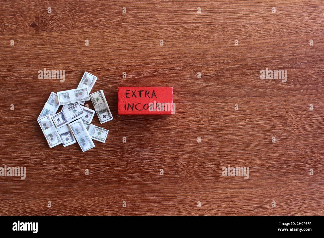 Business and finance concept. Top view pile of money and wooden tiles
