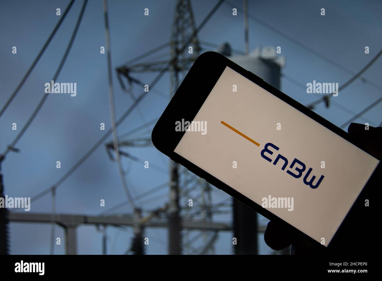 Rheinbach, Germany  5 October 2021,  The brand logo of the energy supplier 'EnBW' on the display of a smartphone in front of a transformation station Stock Photo
