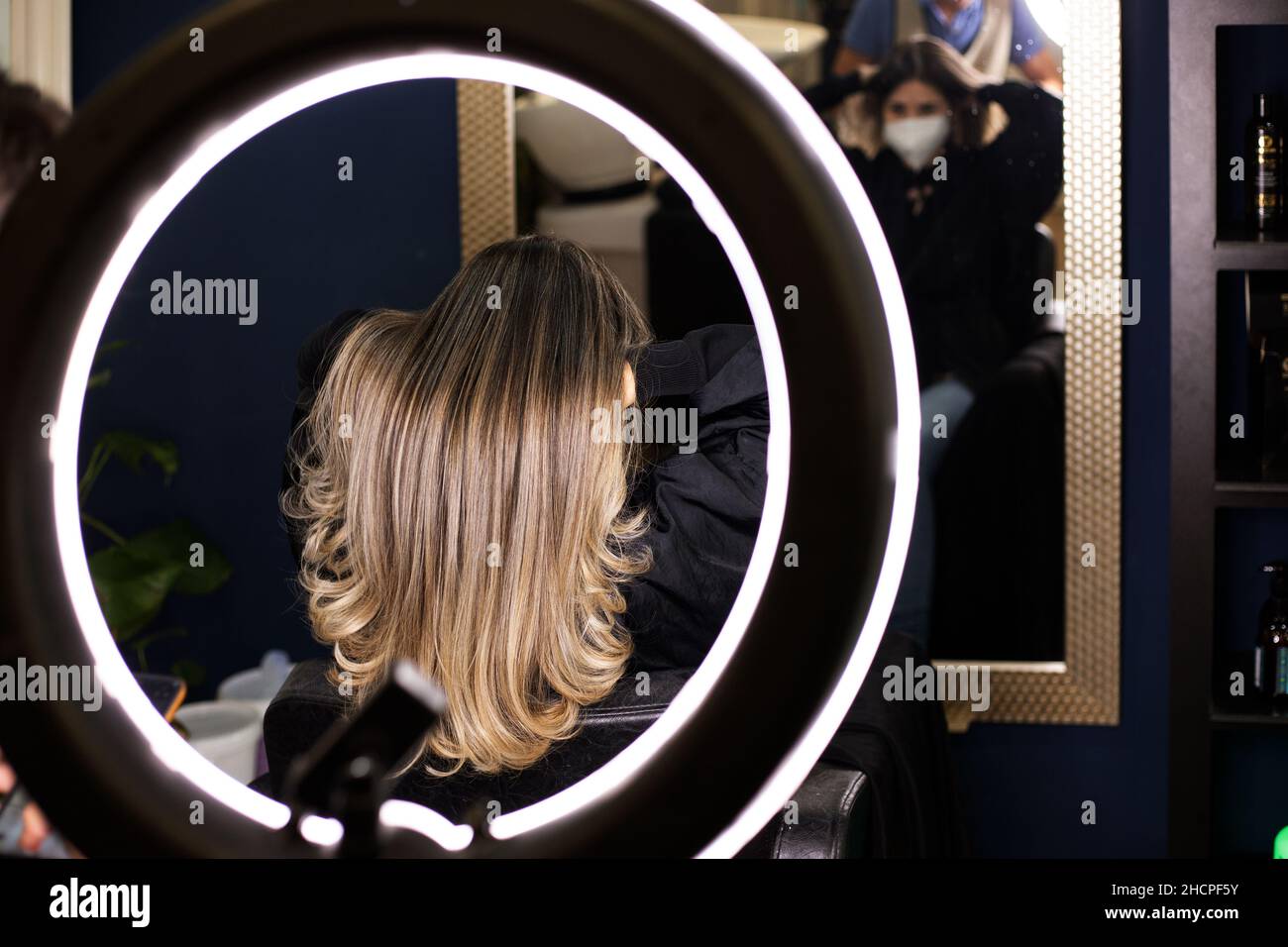 photo of long woman's hair with new look in hairdresser's salon through a light hoop Stock Photo
