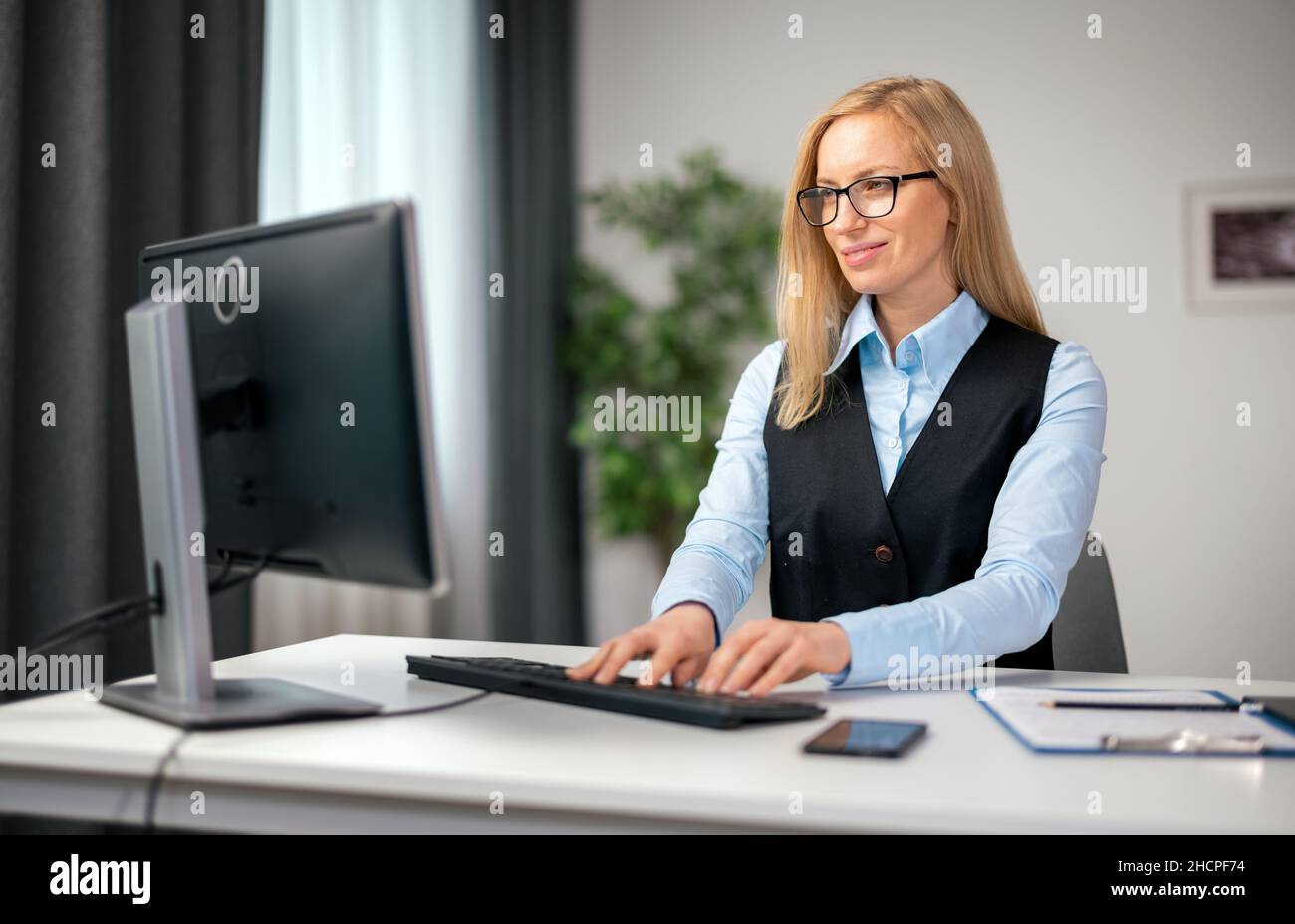 Confident mature woman typing hi-res stock photography and images - Alamy