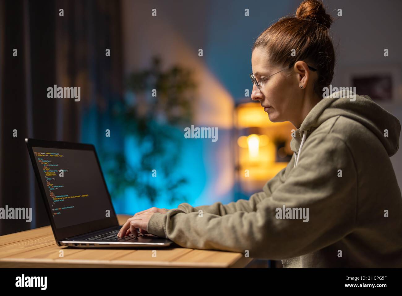Woman using laptop for coding Stock Photo - Alamy