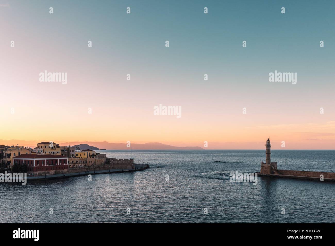 Beautiful sunset at the old Venetian Harbour and lighthouse in Chania, Crete Island - Greece Stock Photo