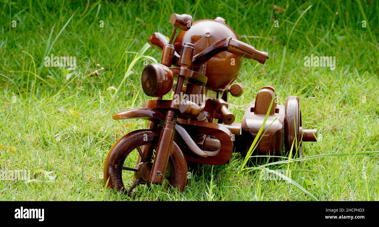 Handicrafts made of teak wood in the form of a motorcycle. Indonesian Art. Home Work Stock Photo