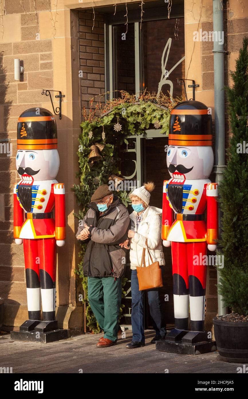 Brightly coloured life size nut cracker Christmas decoration soldiers standing guard outside a restaurant in Perth, Scotland Stock Photo