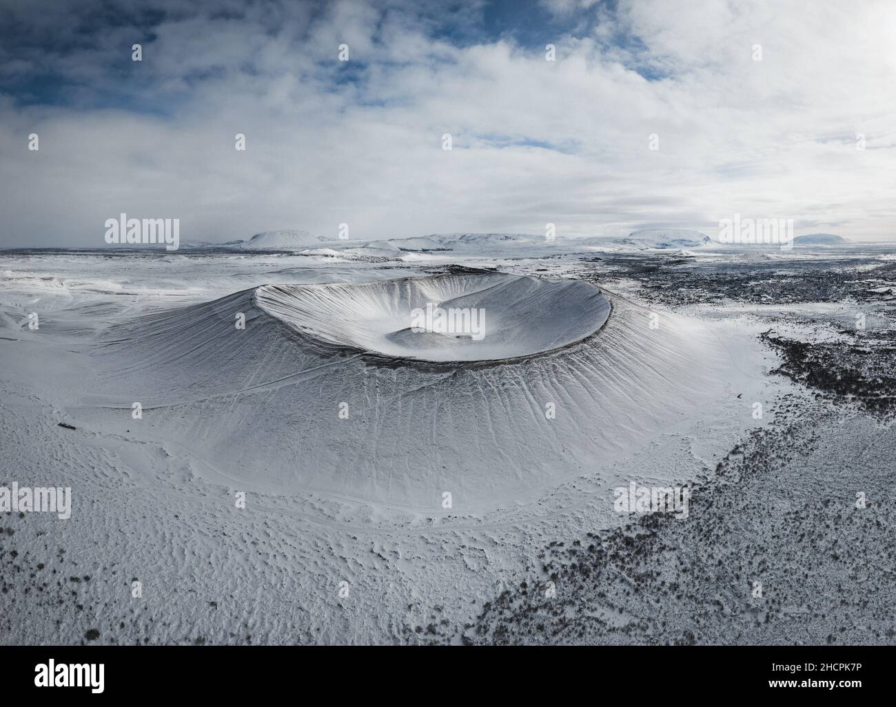 Aerial drone panorama snowy winter landscape view of huge volcano cone crater Hverfjall near Myvatn Reykjahlid Northern Iceland Europe Stock Photo