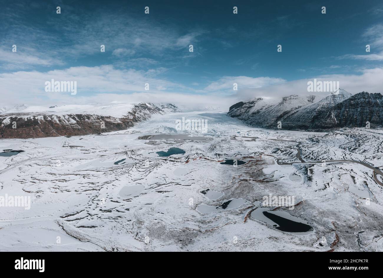 Aerial drone panorama of Iceland Glacier Svinafellsjokul and Vatnajokull in Southern Iceland. Blue sky on a sunny winter day with snow and ice. Stock Photo