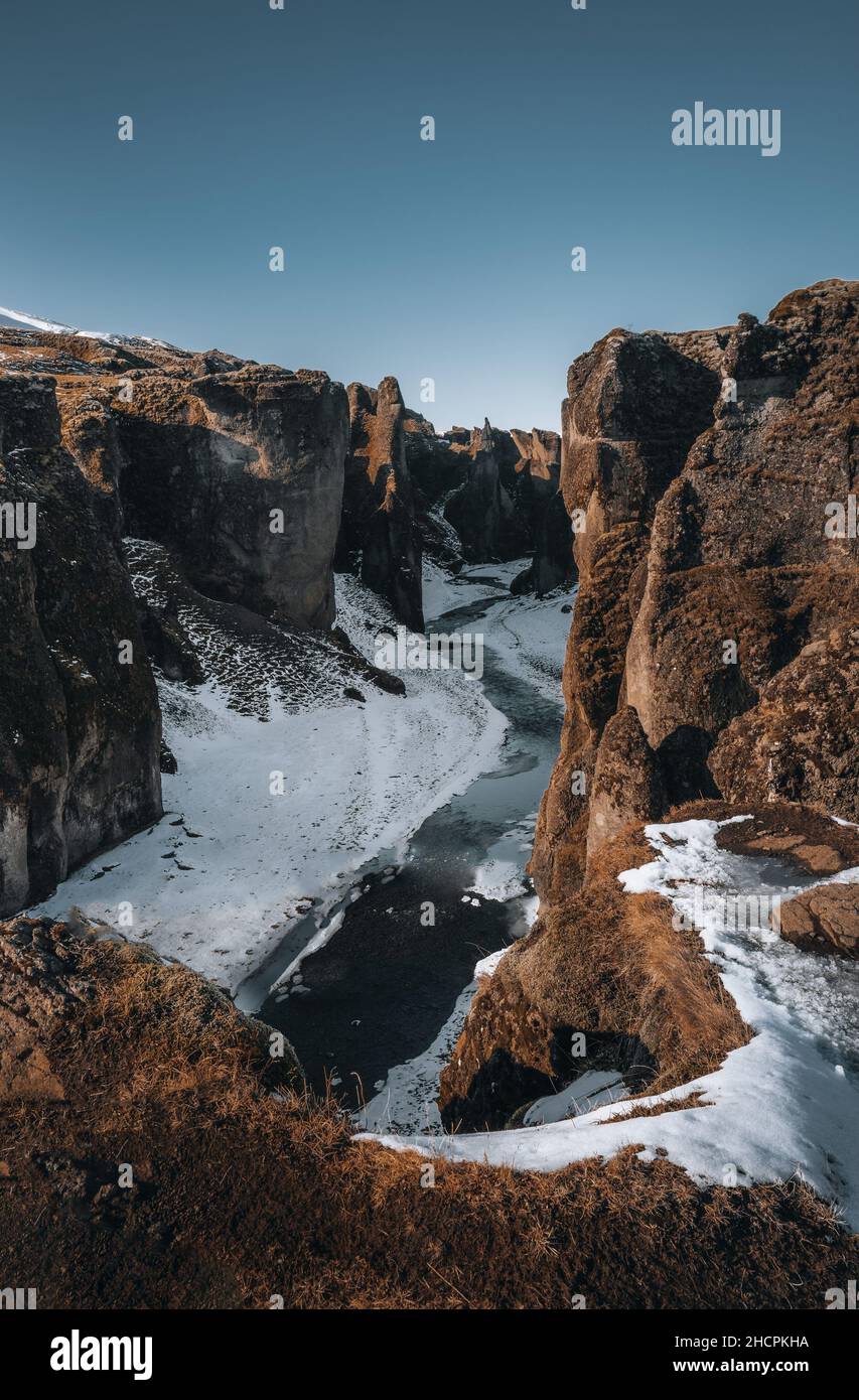 Aerial Drone view of Fjadrargljufur canyon and Fjadra river at winter. White snow and blue river. Iceland near Reykjavik. Stock Photo