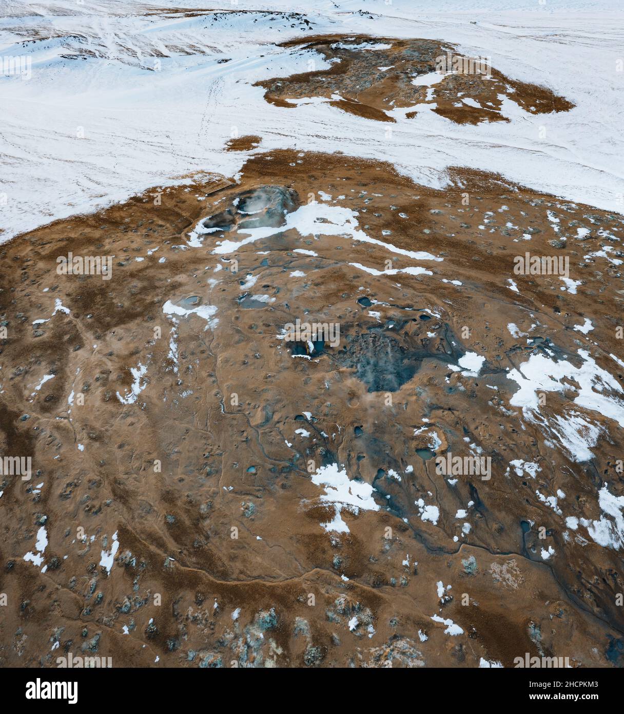 Aerial Drone view of Hverir in Winter with Snow. Icelandic Hverarond is geothermal area in Myvatn, Iceland. Hverir is a famous tourist destination Stock Photo