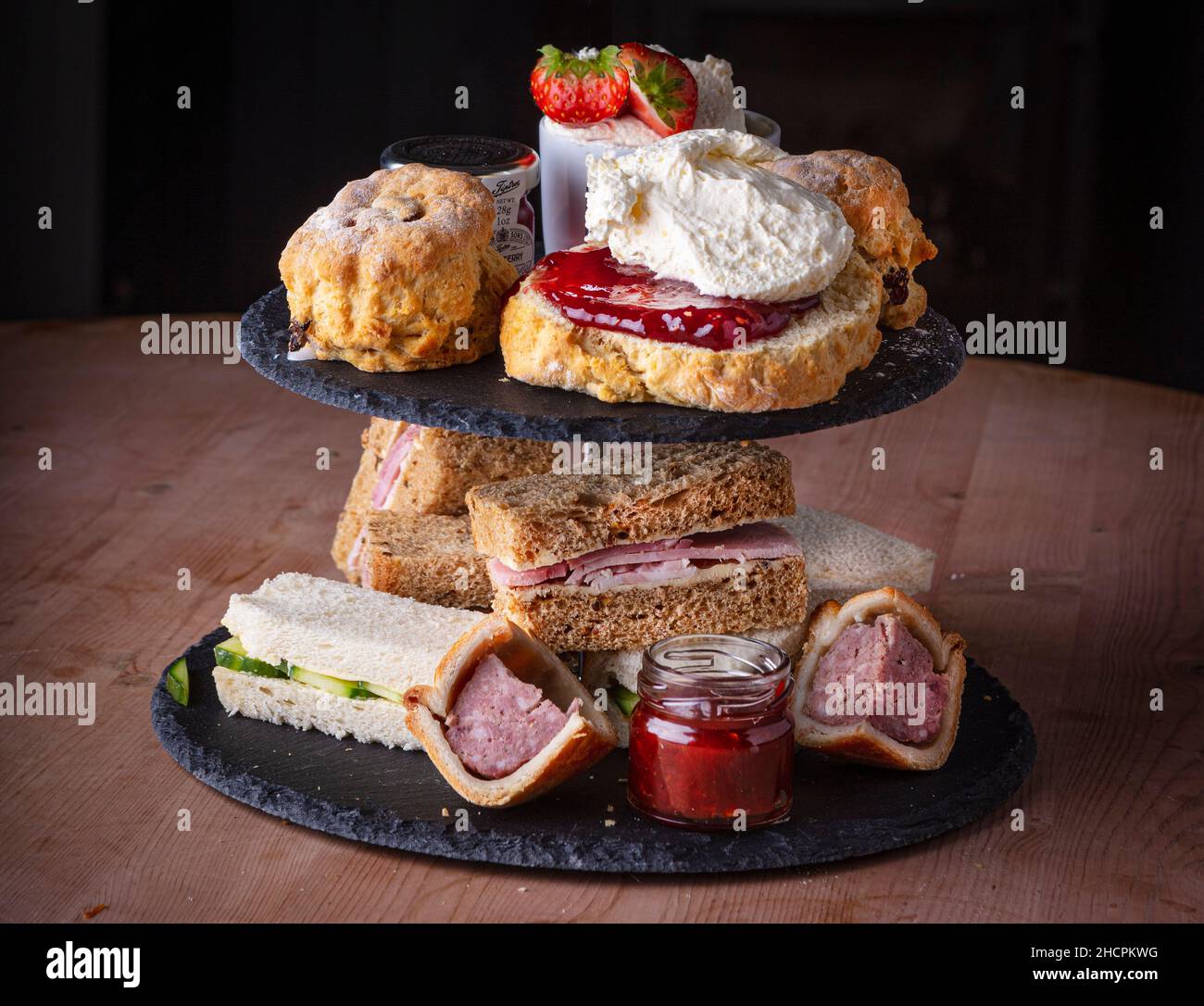 Afternoon tea with cakes and sandwiches Stock Photo