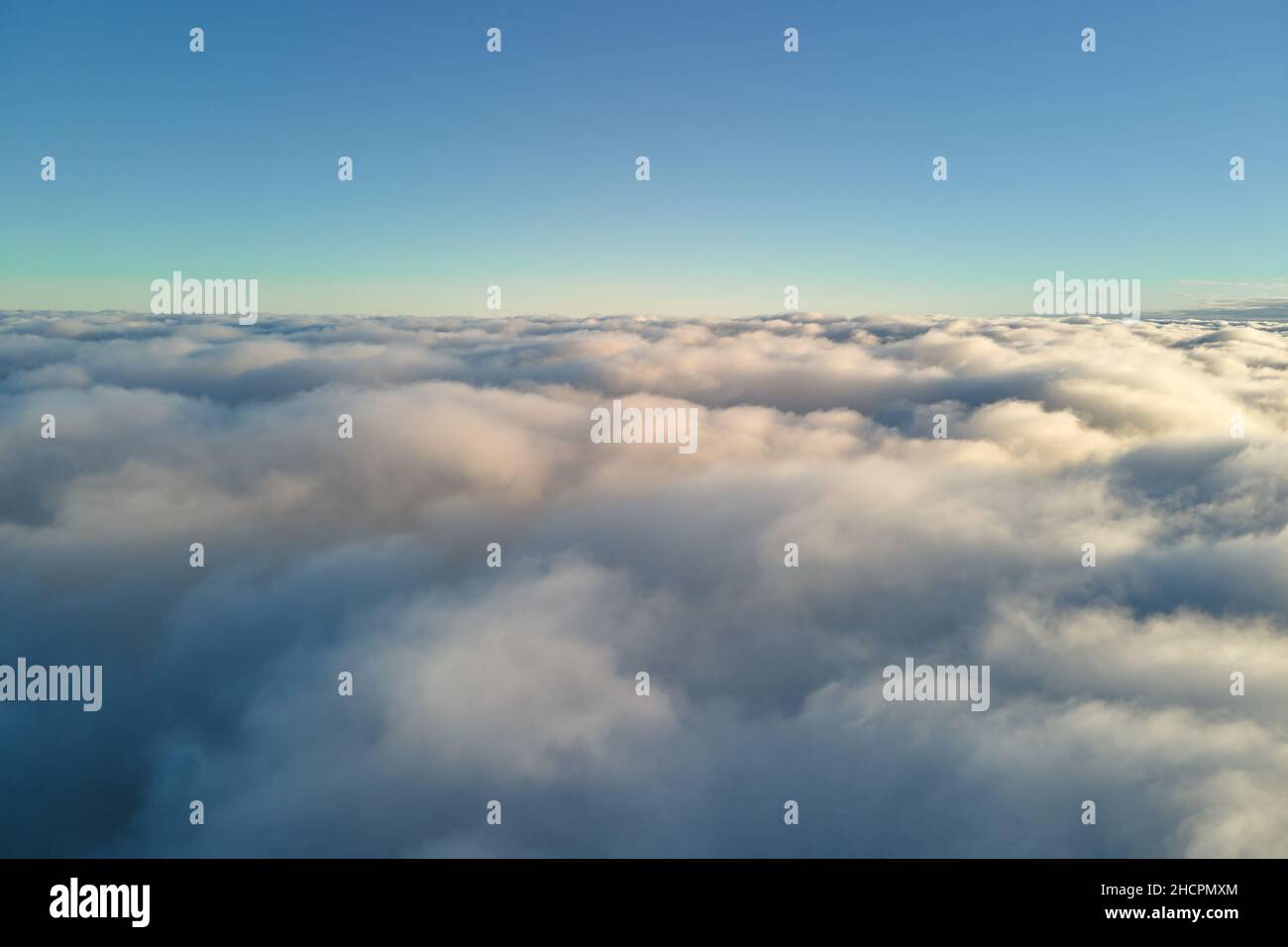 Aerial view from airplane window at high altitude of dense puffy ...