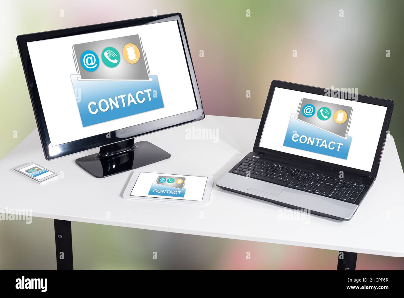 Contact concept shown on different information technology devices Stock Photo
