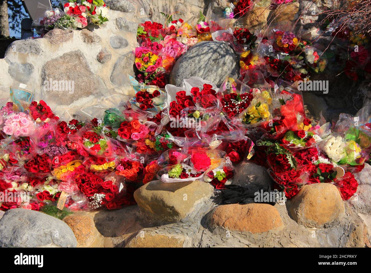 Many gorgeous bouquets of fresh flowers stacked high as an elegant ...