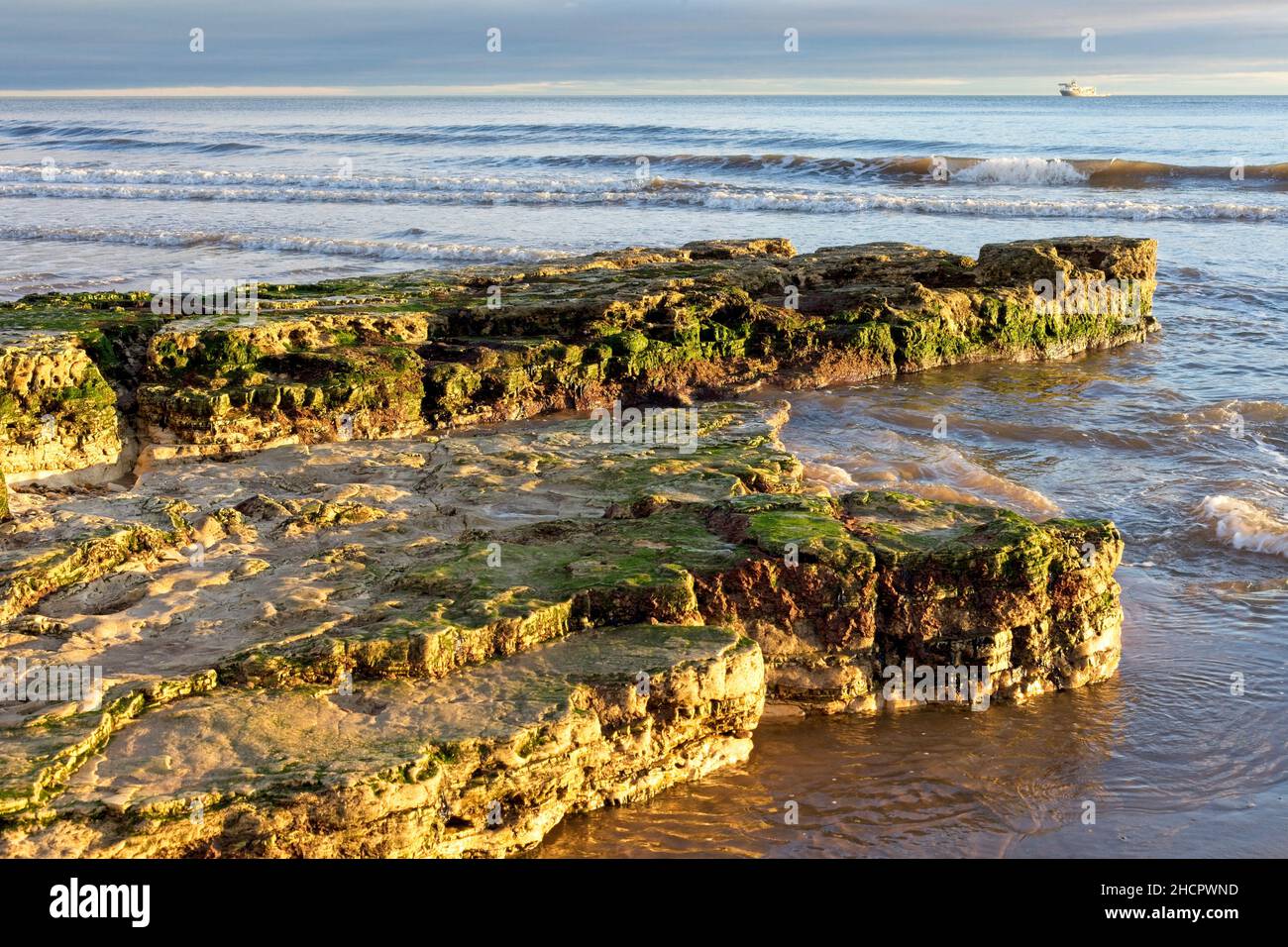 Rocks protrude out into the North Sea on Roker Beach near Sunderland in ...