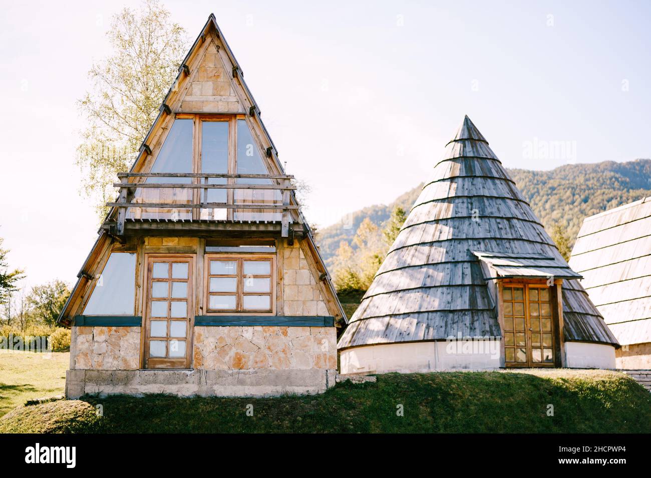 Triangular stone house with a terrace next to the conical house ...