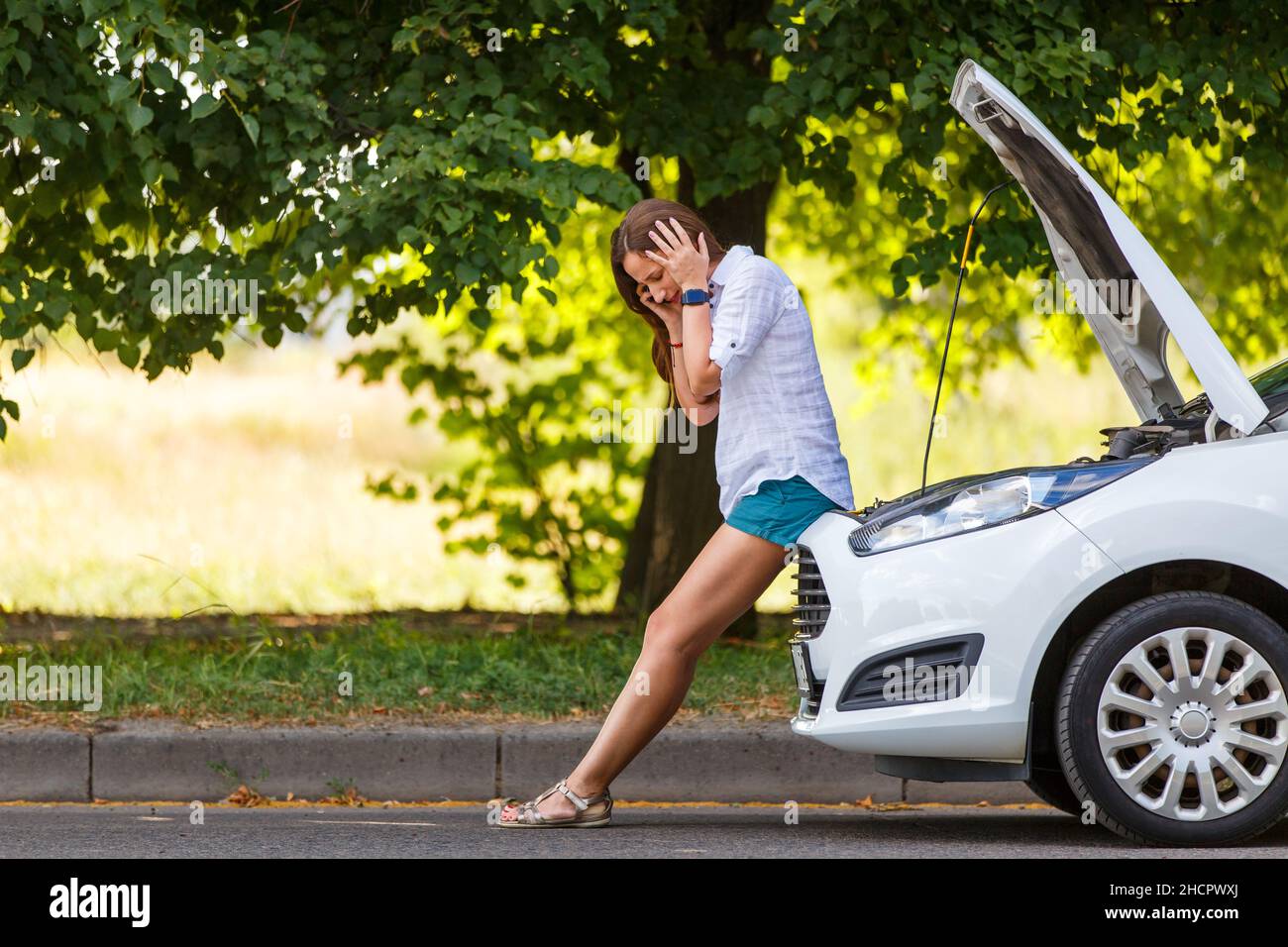 Young woman driver having troubles with engine of her car Stock Photo ...