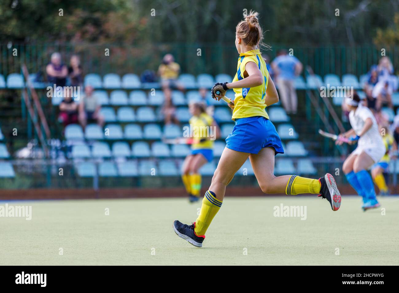 Young teenage field hockey player running on the pitch Stock Photo Alamy