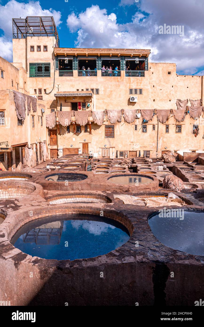 Dyed water fill in tanks in tannery against old residential building Stock Photo