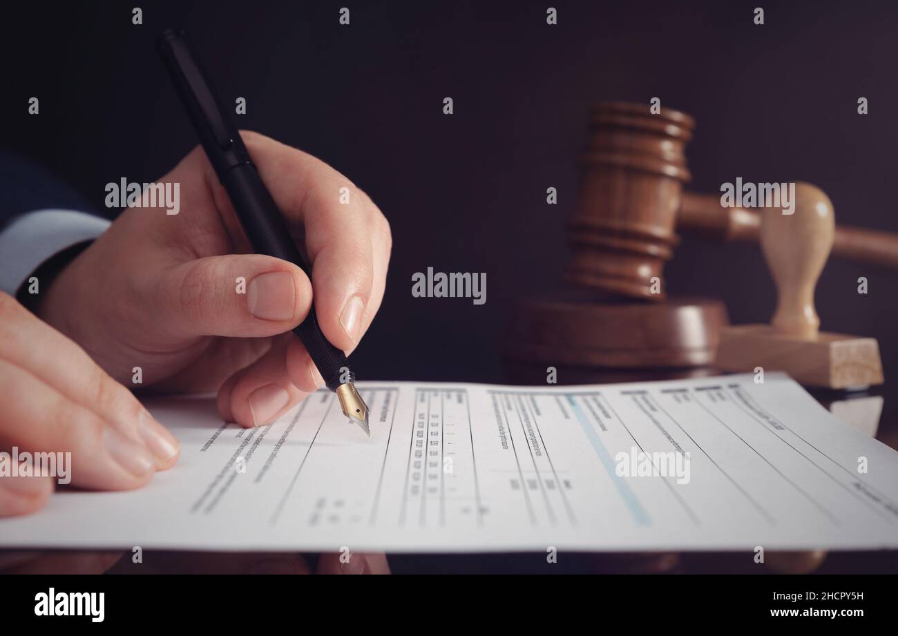 Attorney, clerk, bookkeeper working in the office. Signing contract or agreement concept Stock Photo