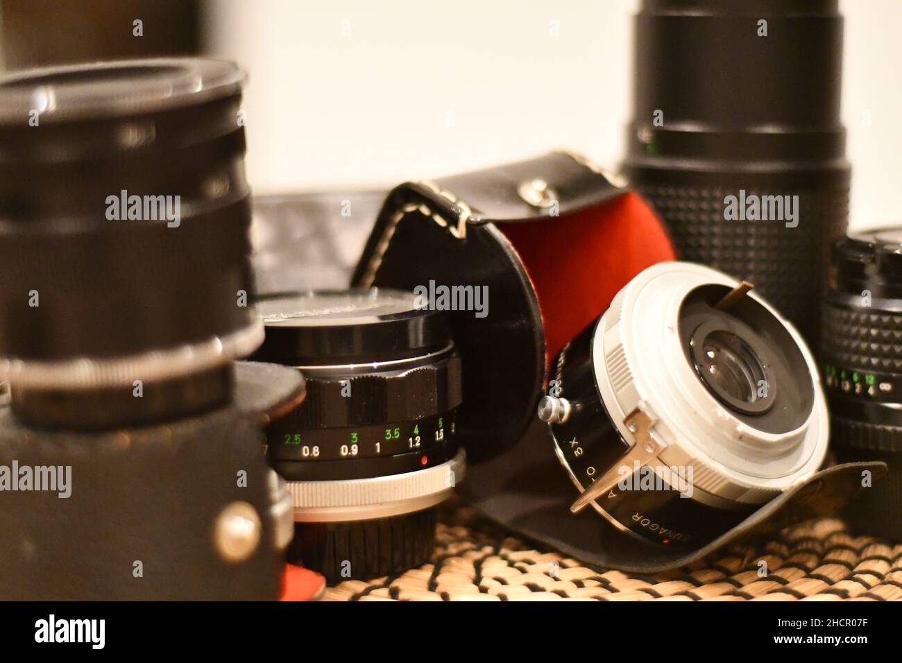 1970s Minolta Camera lenses with their original black leather and red internal cases Stock Photo