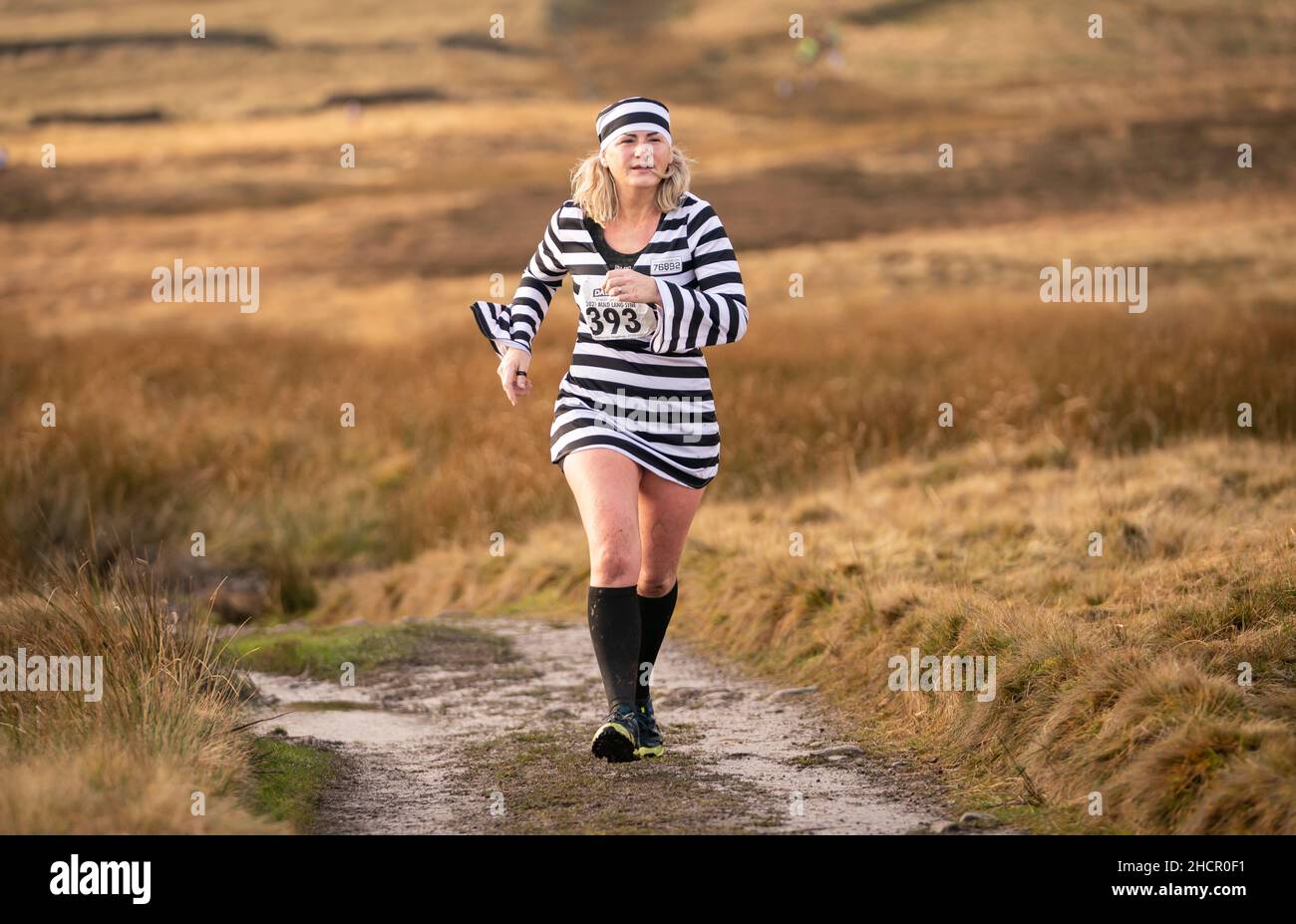 A competitor in fancy dress run across the Pennine tops near Haworth, West Yorkshire, in the annual Auld Lang Syne Fell race which attracts hundreds of runners every year. Picture date: Friday December 31, 2021. Photo credit should read: Danny Lawson/PA Wire Stock Photo