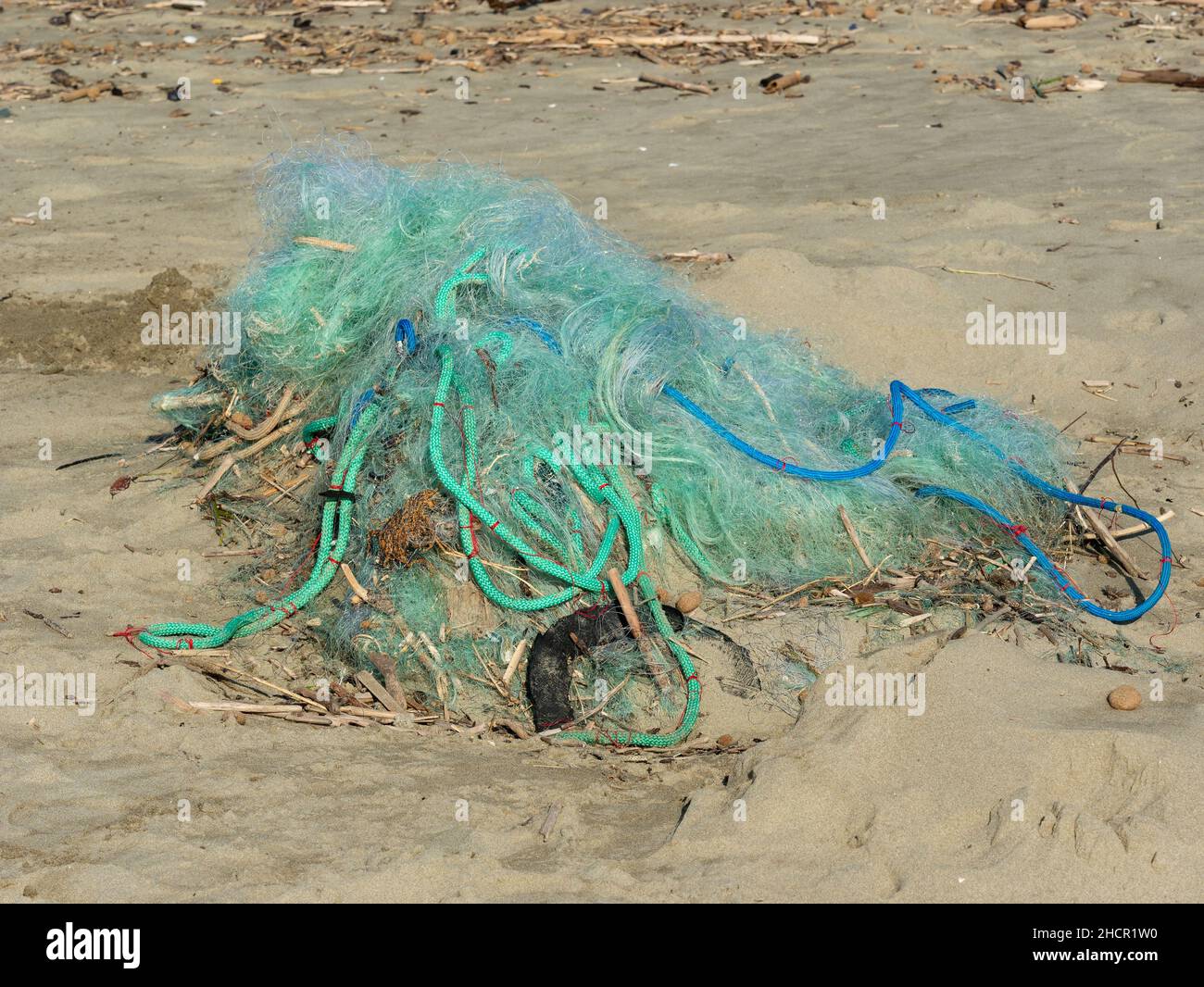 tangled fishing nets arrived on the sand after a storm, a symbol of  pollution and problems for marine life Stock Photo - Alamy