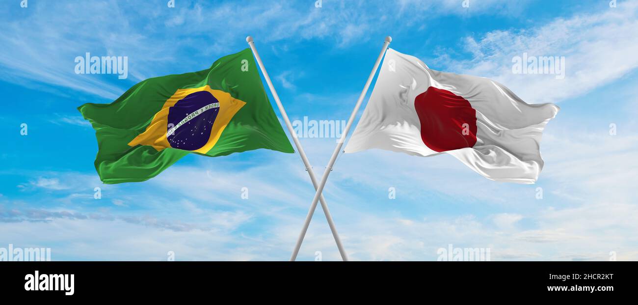 crossed national flags of Brazil and japan flag waving in the wind at ...