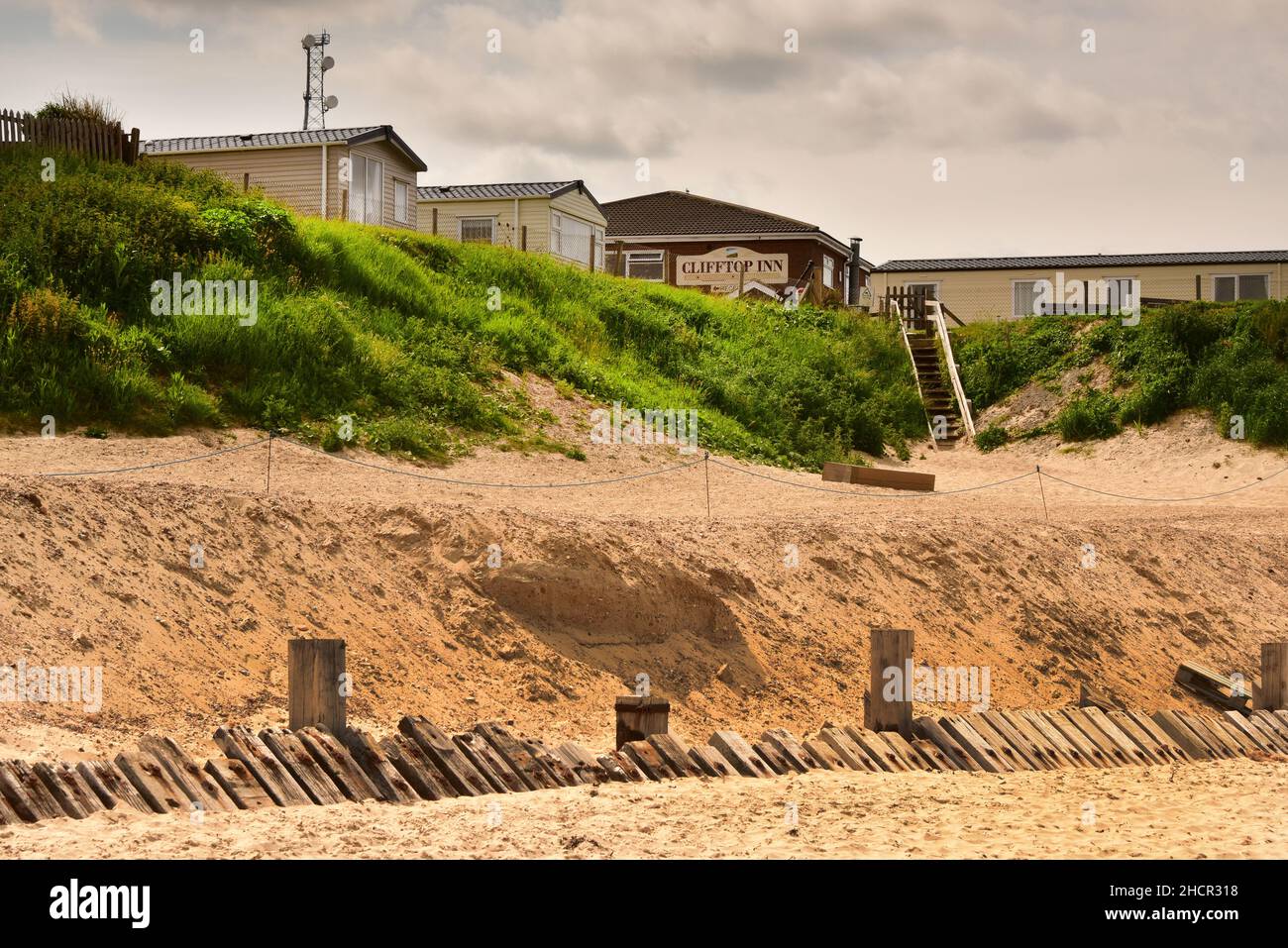Houses and Coastal Erosion with Sandscaping at the Beach and Cliffs at ...