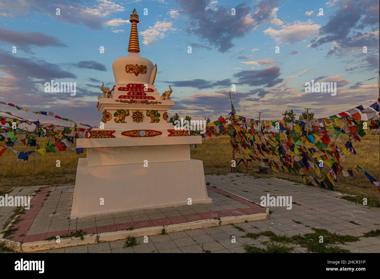 Stupa and flags near Geden Sheddup Choikorling Monastery, Tibetan Buddhist monastery in Elista, Republic of Kalmykia, Russia Stock Photo