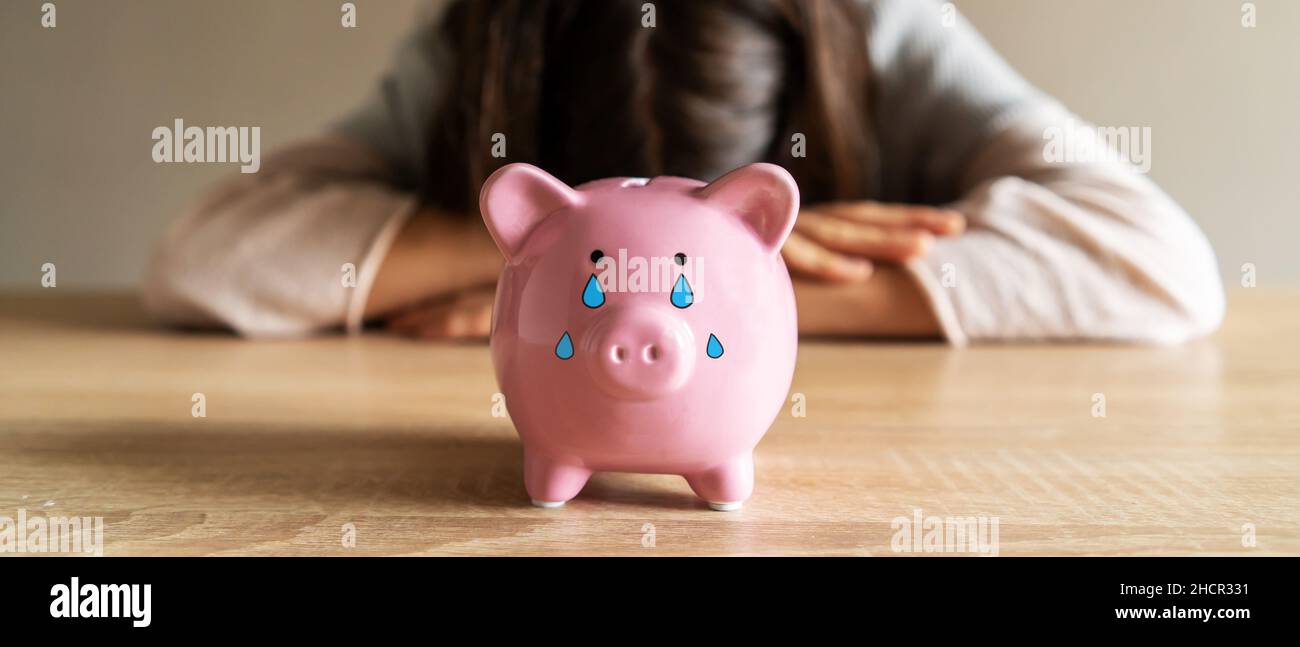Sad girl with a crying piggy bank Stock Photo - Alamy