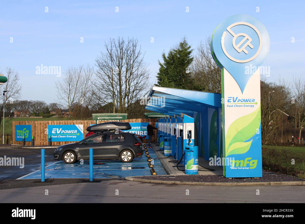 Row of electric charging points for cars at Wrightington garage adjacent to junction 27 M6 Lancashire. Stock Photo