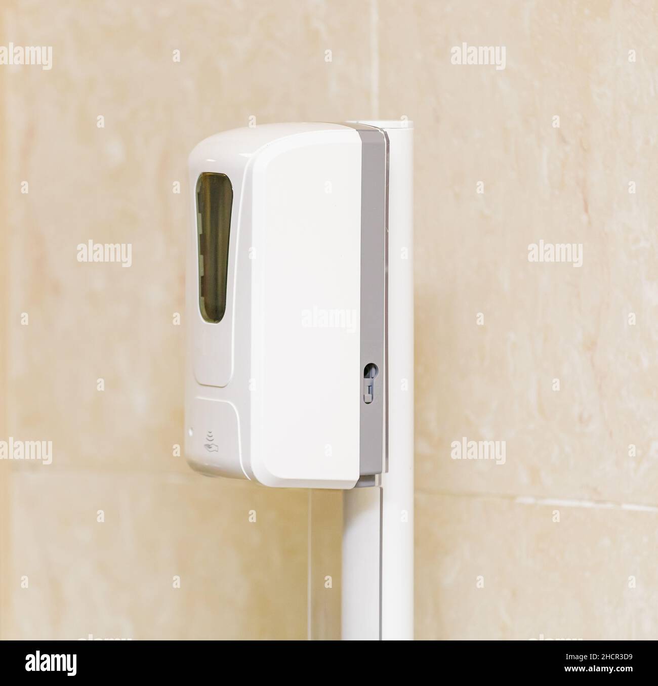 Automatic non-contact hand sanitizer dispenser in public places. Close-up. Stock Photo