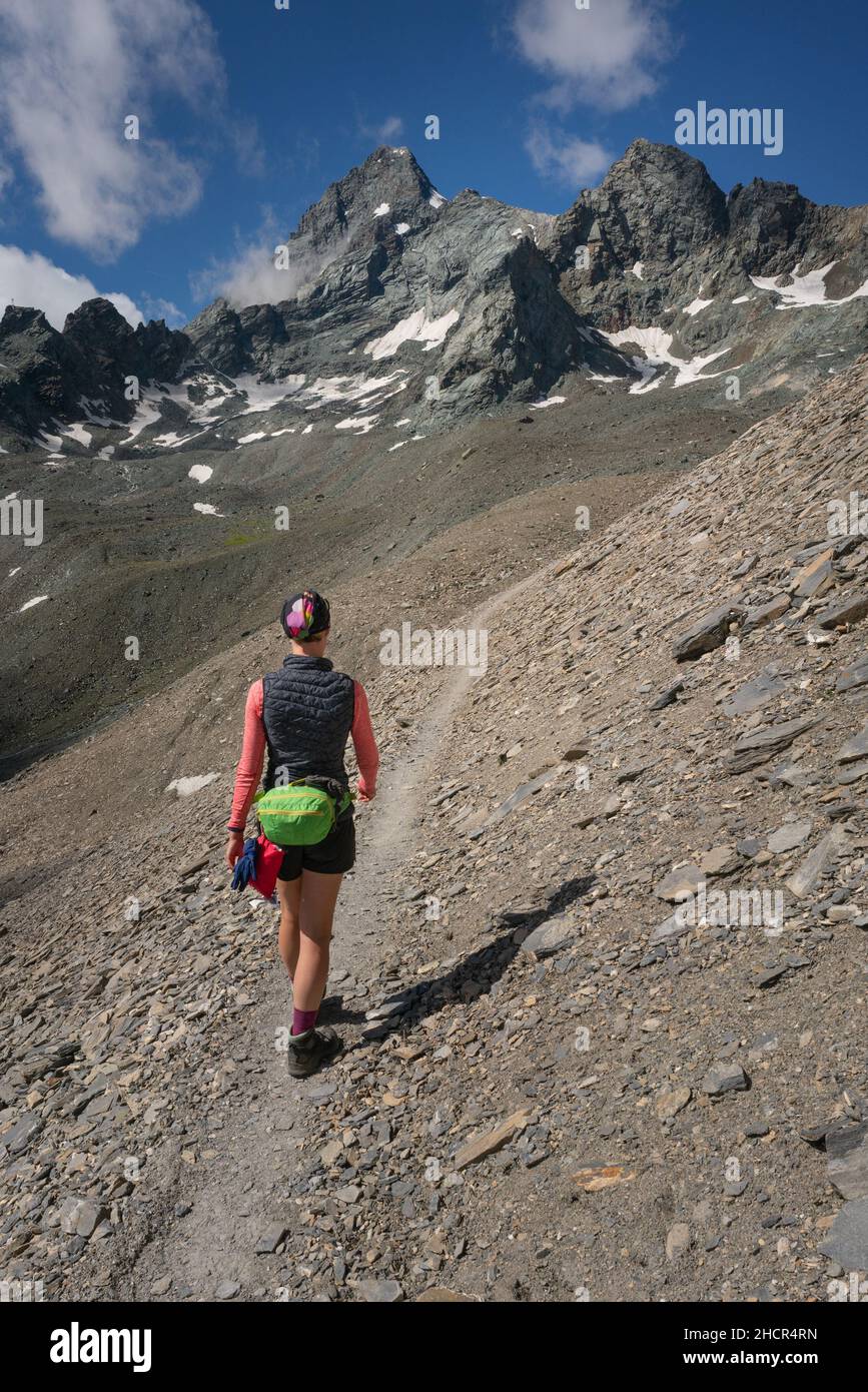 Female hiker going uphill on a trail to Grossglockner in High Tauern ...