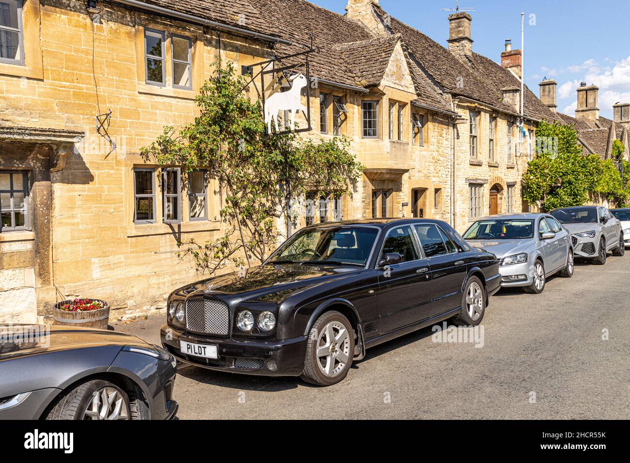 A Bentley with a personalised number plate P1LDT parked outside the Lamb Inn Hotel in Sheep Street in the Cotswold town of Burford, Oxfordshire UK Stock Photo