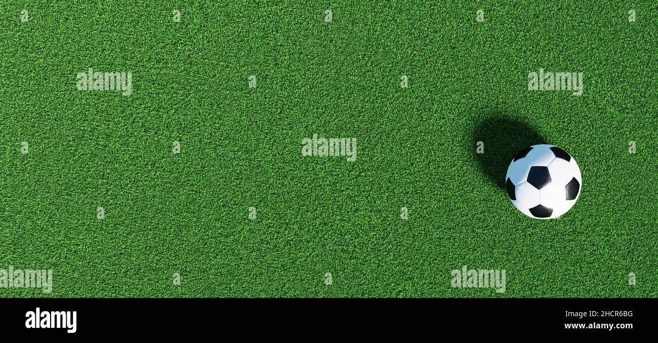 Soccer ball on a green grass as a panorama background, banner size Stock Photo