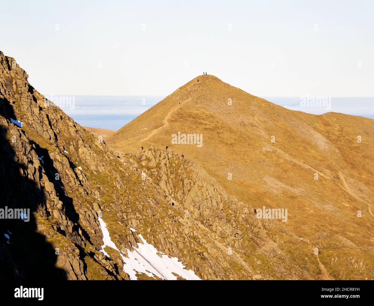 Striding Edge on Helvellyn and Catstycam with hikers in the Lake District, UK. Stock Photo