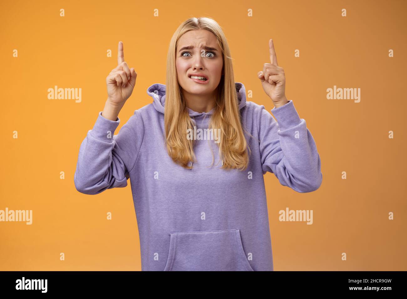 Worried perplexed unsure cute blond woman presenting project standing ...