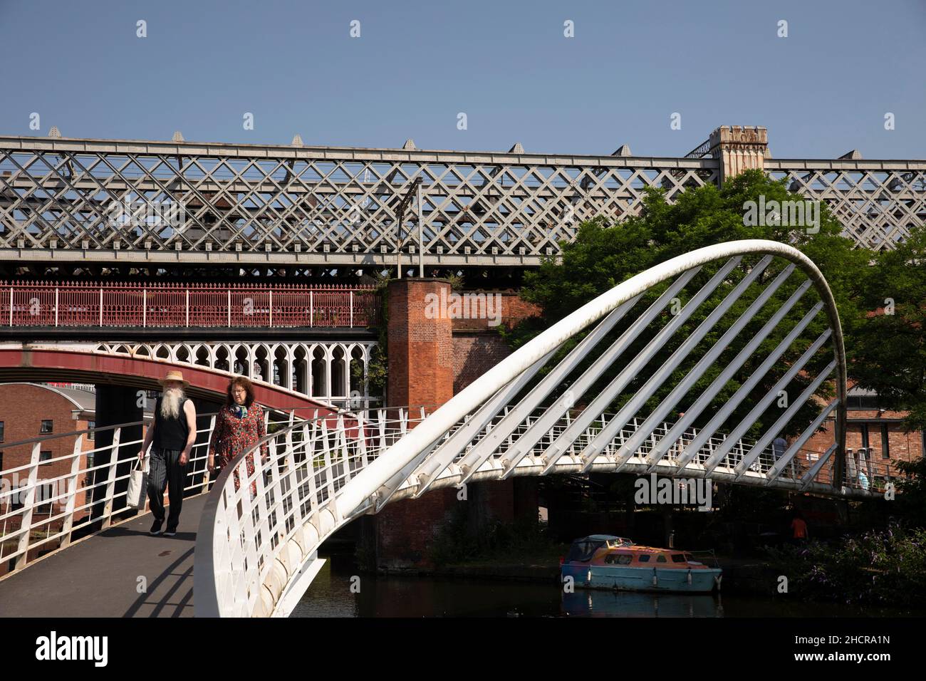 UK, England, Manchester, Castlefield, Merchant’s Bridge crossing Bridgewater Canal basin at Railway Viaduct Stock Photo